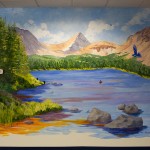 Health care center mural of a blue lake and mountains by Boulder Murals