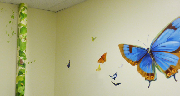 hand painted mural for Mountainland Pediatrics with birdhouses, bears, butterflies, owls, turtles, ducks, deer, fox, rabbits, flowers, mountain lion, 