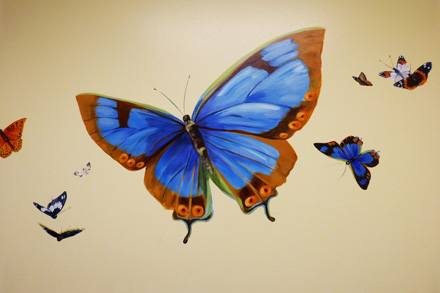 hand painted mural for Mountainland Pediatrics with birdhouses, bears, butterflies, owls, turtles, ducks, deer, fox, rabbits, flowers, mountain lion, 