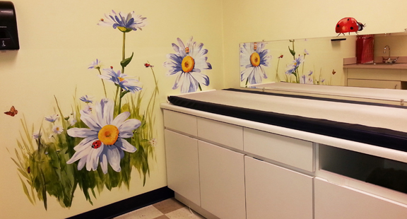 Big sunflowers and ladybugs exam room. hand painted mural for Mountainland Pediatrics with birdhouses, bears, butterflies, owls, turtles, ducks, deer, fox, rabbits, flowers, mountain lion, 