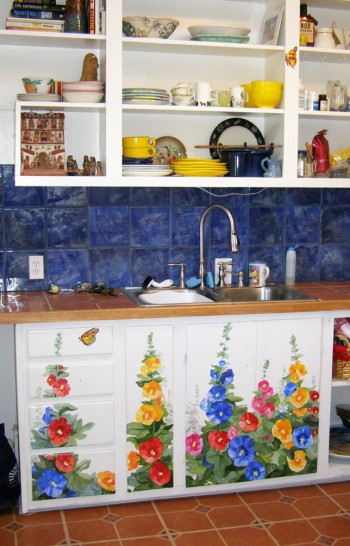 hand painted mural of hollyhocks on kitchen cabinets by Boulder Murals