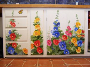 hand painted mural of hollyhocks on kitchen cabinets by Boulder Murals