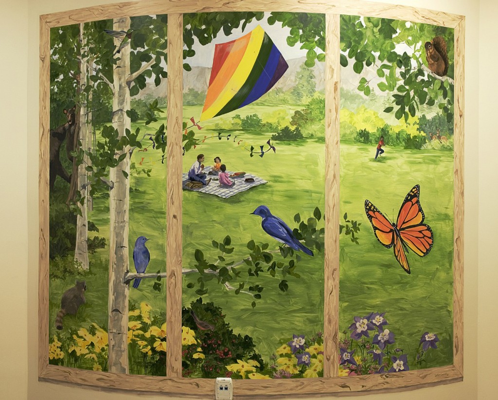 hand painted mural in Boulder Community Health Pediatric playroom  by Boulder Murals bears, humming birds, butterflies, kites, picnic