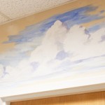 hand painted mural in Day Treatment Center - Community Reach Center by Boulder Murals, dogs, playground, lamp post, tree, squirrel, vegetables,