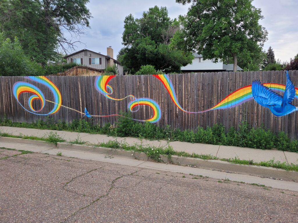 Rainbow mural on fence